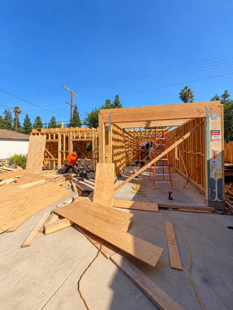 Wood wall framing going up on the slab of the Encino ADU