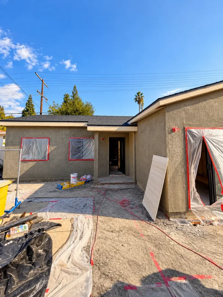 Stucco base coat on the Encino ADU walls, windows masked