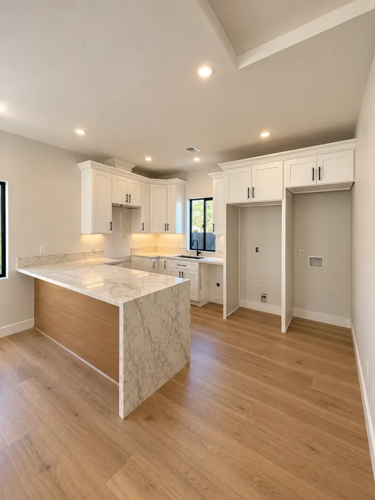 Kitchen in the Encino ADU with a waterfall-edge peninsula and wood panel side